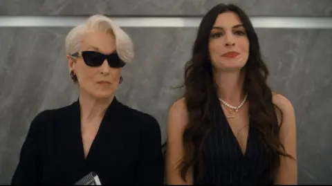 20th Century Studios Meryl Streep and Anne Hathaway standing in a lift together in The Devil Wears Prada 2
